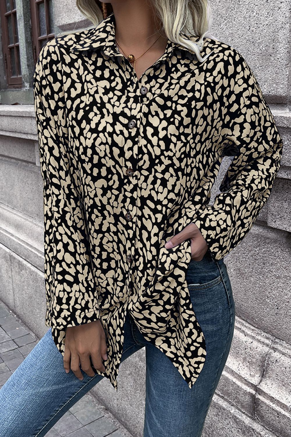 Women's black and beige abstract spot print oversized button-up shirt with collar.