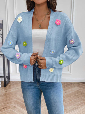 Light blue knit cardigan with embroidered multicolor flowers, open front, long sleeves.