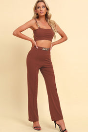 Caramel chain strap crop top and high-waist trousers with chain belt detail