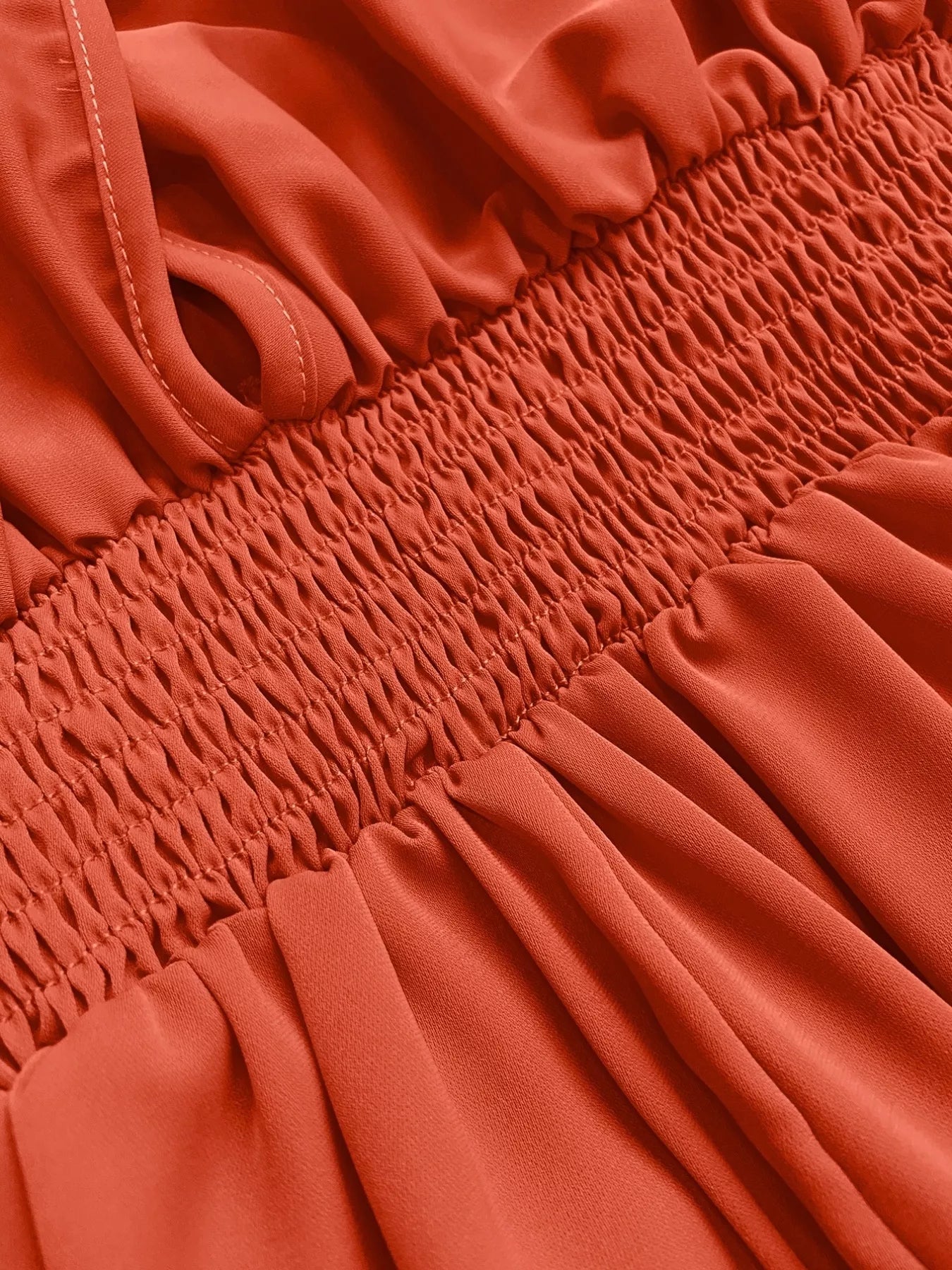 Orange-red maxi dress with smocked bodice and V-neck detail