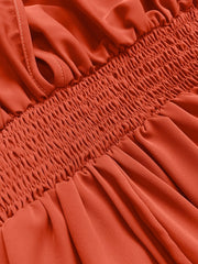 Orange-red maxi dress with smocked bodice and V-neck detail