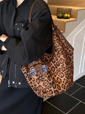 Chic leopard print tote bag in brown with leather trim and a glasses holder detail.