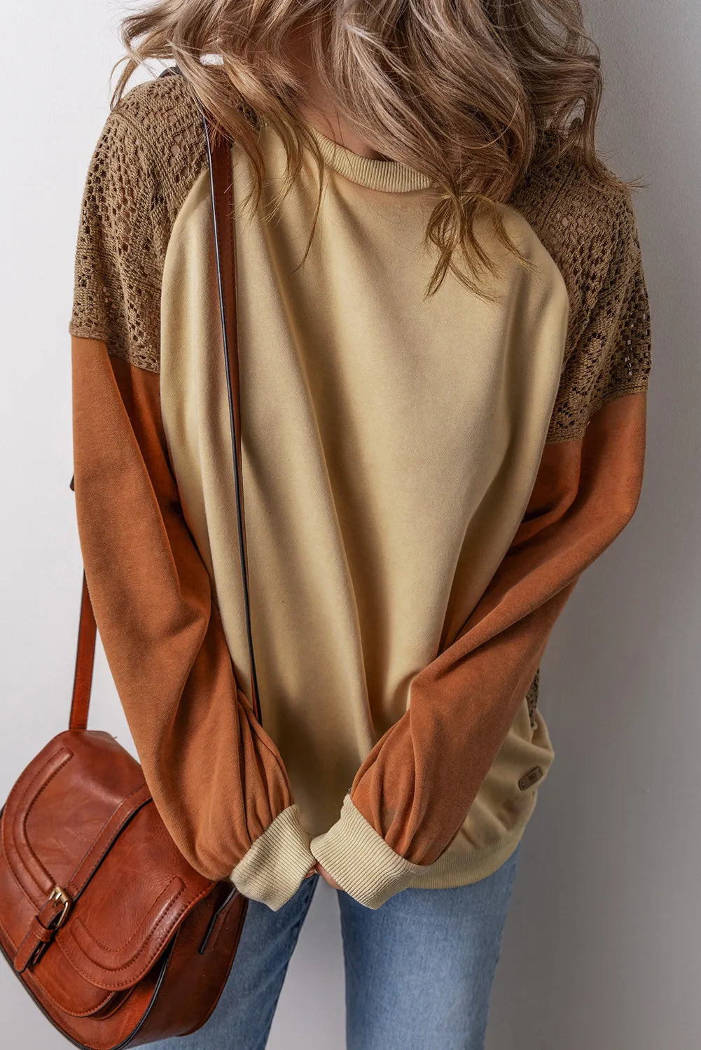 Tan sweatshirt with crochet yoke and raglan sleeves, featuring colorblock design.