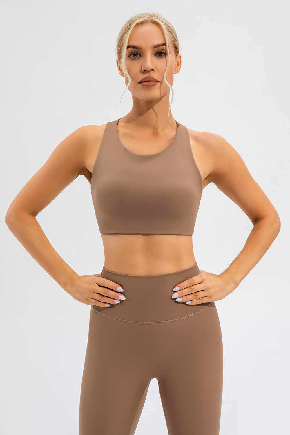 Camel sports bra with asymmetric cutout detail and racerback.