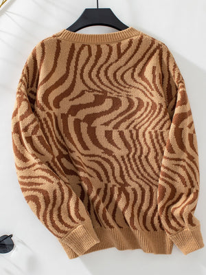 Camel wavy knit crewneck sweater with brown abstract pattern.