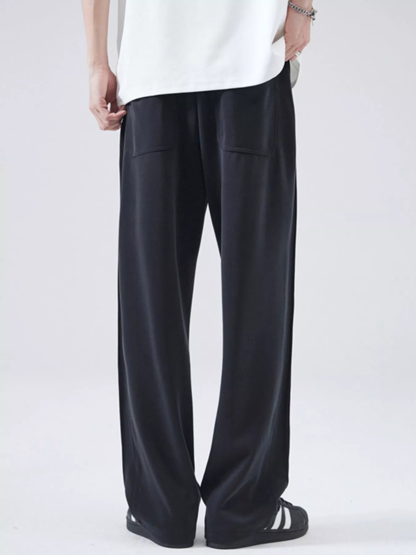 Black relaxed fit drawstring casual pants with two front pockets.