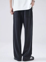 Black relaxed fit drawstring casual pants with two front pockets.