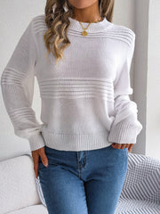 White ribbed yoke knit sweater with mock neck and long sleeves, styled with jeans.