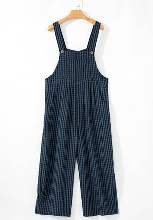 Textured dark blue gingham wide-leg overalls with button detail and pockets.