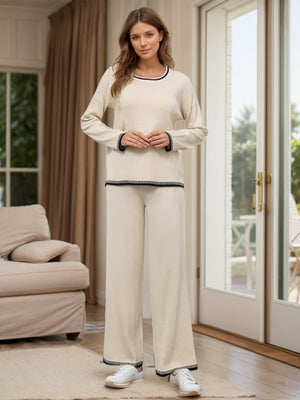 Cream acrylic sweater set with contrast trim on neckline, cuffs, and hem.