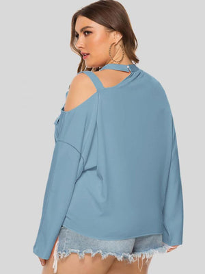 Light blue cold shoulder blouse with cutout detail and long sleeves.