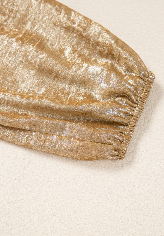 Gold peplum blouse with ruched sleeve detail and shimmering fabric.