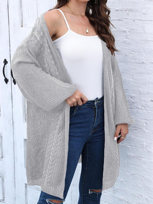 Light gray cable knit cocoon cardigan with open front and long sleeves.