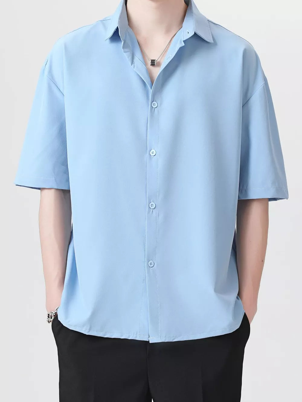 Men's light blue short-sleeve button-down shirt with a relaxed fit and spread collar.