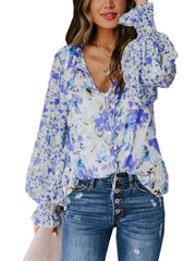 Blue floral print tie-detail blouse with smocked cuffs and V-neck.