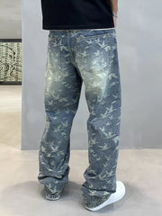 Loose-fit denim jeans with all-over bird print and distressed wash.