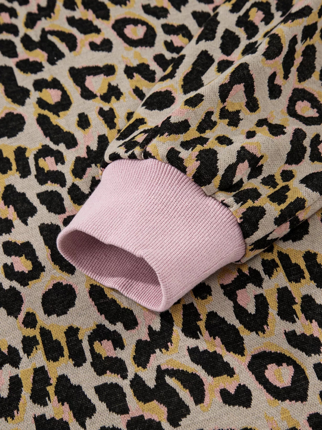 Cozy leopard print loungewear set with pink ribbed cuffs and neckline detail.