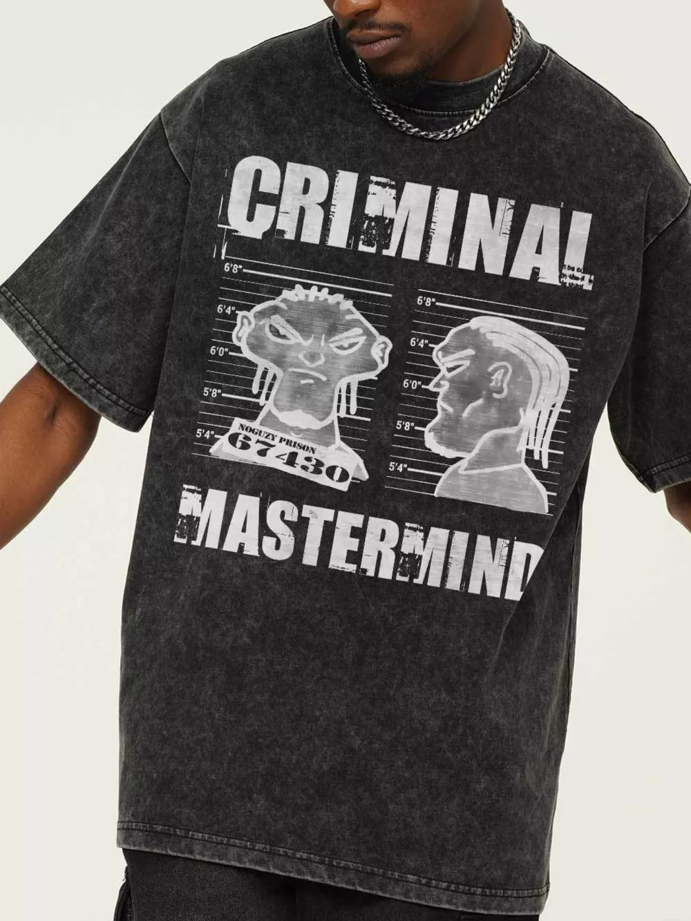 Dark gray oversized cotton tee with bold "CRIMINAL MASTERMIND" graphic and cartoon mugshot prints.
