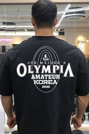 Black oversized tee with Joe Weider's Olympia Amateur Korea 2020 graphic print.