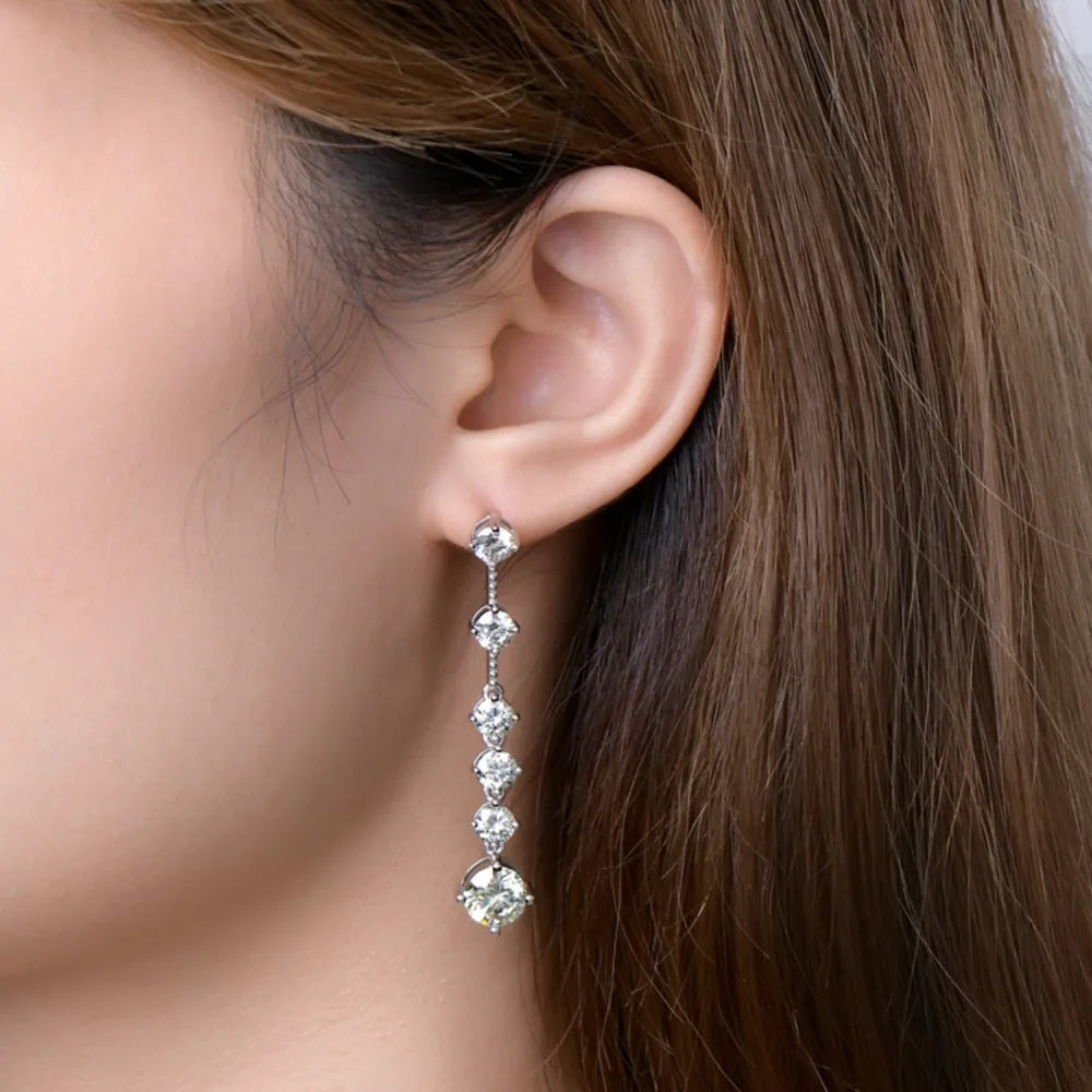 Silver cascading diamond drop earrings with five brilliant stones.