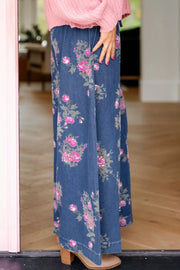Floral print high-waisted wide-leg jeans in blue denim with pink flowers.