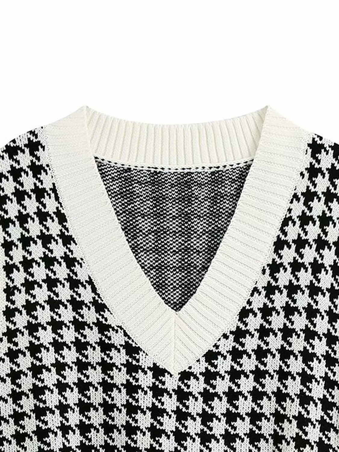 Houndstooth knit v-neck tank top in black and white with white trim.