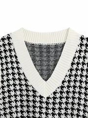 Houndstooth knit v-neck tank top in black and white with white trim.