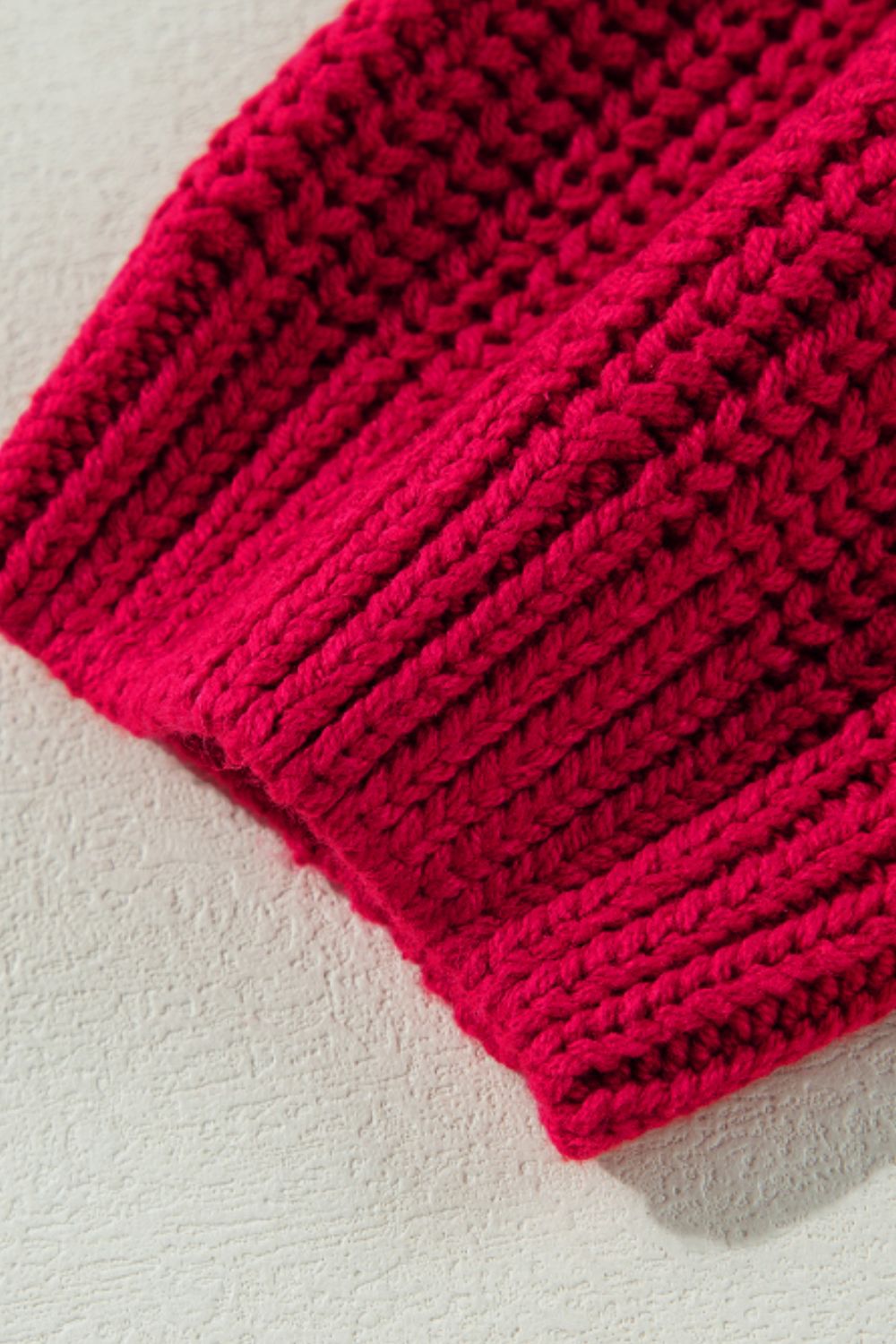 Deep red acrylic knit sweater with ribbed texture detail