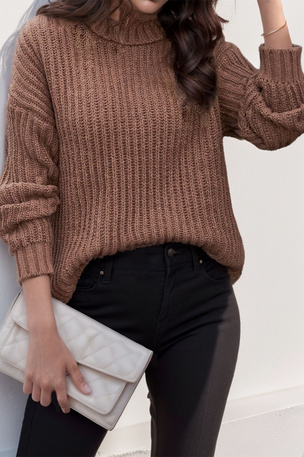 Brown chunky ribbed turtleneck sweater with relaxed fit and balloon sleeves.