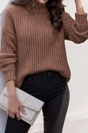 Brown chunky ribbed turtleneck sweater with relaxed fit and balloon sleeves.
