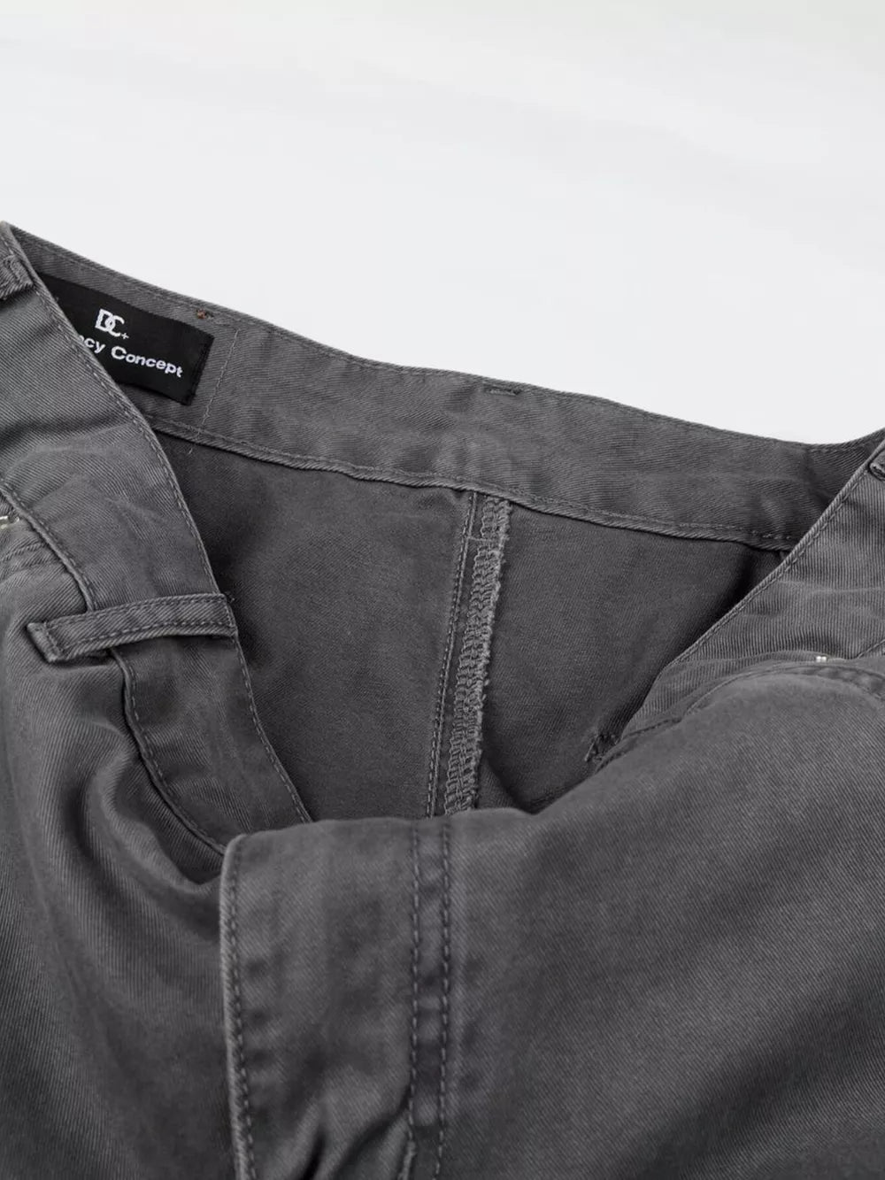 Men's relaxed fit grey cotton cargo capris with button closure and visible stitching details.