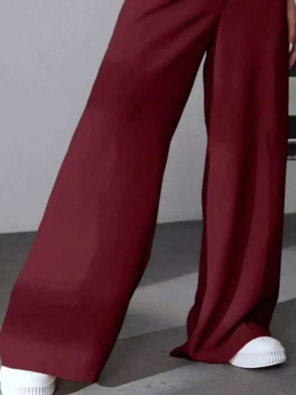 Burgundy high-waisted pleated wide-leg maternity trousers with a casual flowy fit.