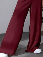 Burgundy high-waisted pleated wide-leg maternity trousers with a casual flowy fit.
