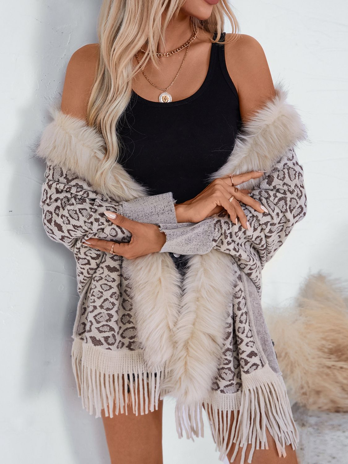 Leopard print cardigan with faux fur trim and fringe detail, in beige and brown acrylic.