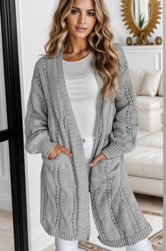 Light gray cable knit open-front cardigan with pockets and intricate stitch details.