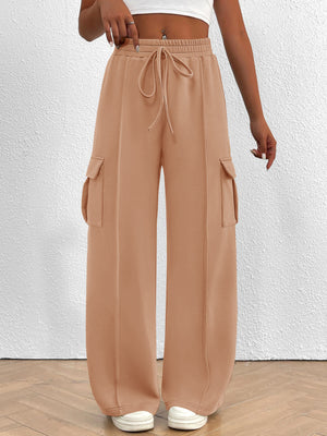 Apricot high waist cargo sweatpants with drawstring and side pockets.