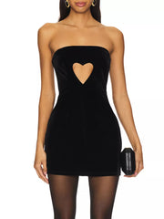 Black velvet mini dress with heart cutout detail, strapless neckline, and bodycon fit.