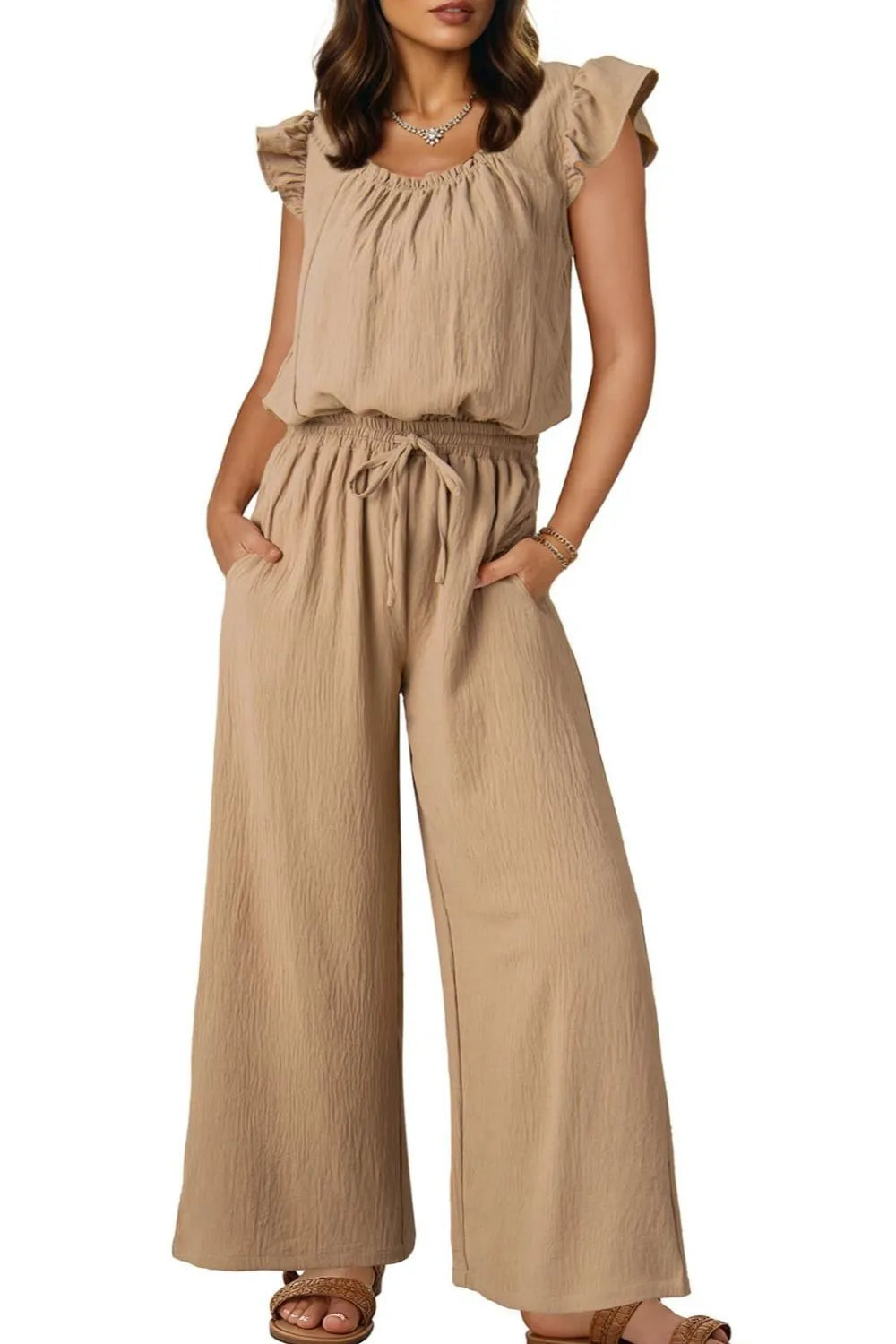 Tan textured drawstring palazzo jumpsuit with ruffle sleeves and wide legs.