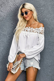 White off-shoulder blouse with lace yoke and balloon sleeves.