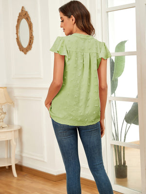 Flutter sleeve Swiss dot blouse in Matcha Green with a V-neck and button detail.