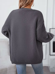 Dark gray chunky knit open-front cardigan with pockets and cable detail on sleeves.