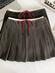Chic drawstring pleated skirt in dark gray and black with red and white drawstrings.