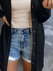 Black button-down cotton cardigan worn open over a cream waffle knit tank and denim shorts.