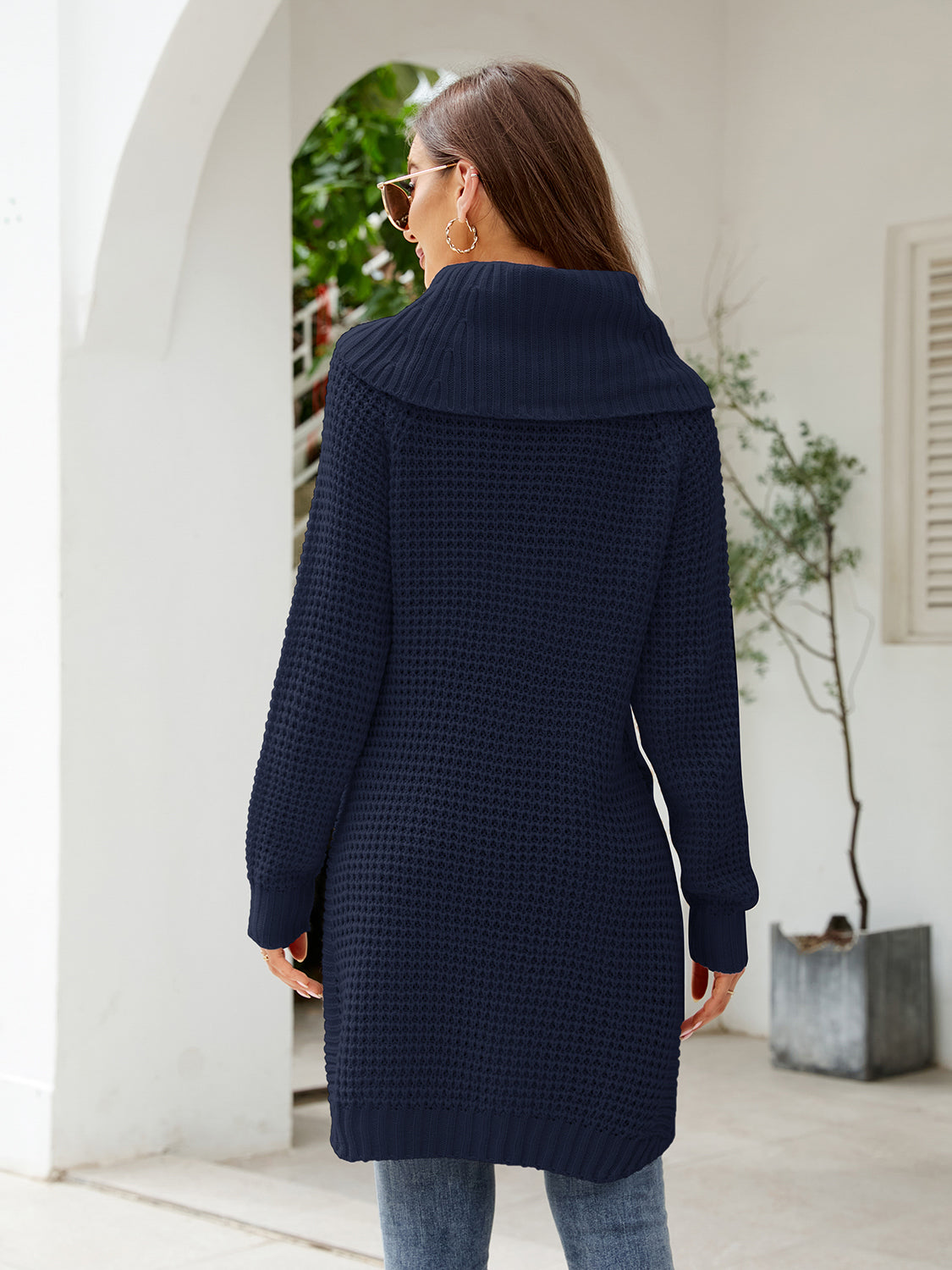 Dark blue waffle knit tunic with cowl neckline and long sleeves.