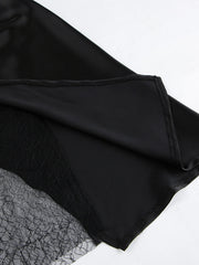 Black midi skirt with sheer lace panel detail and asymmetrical hem.
