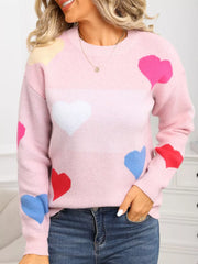 Pink acrylic knit sweater with multicolor hearts and round neck.