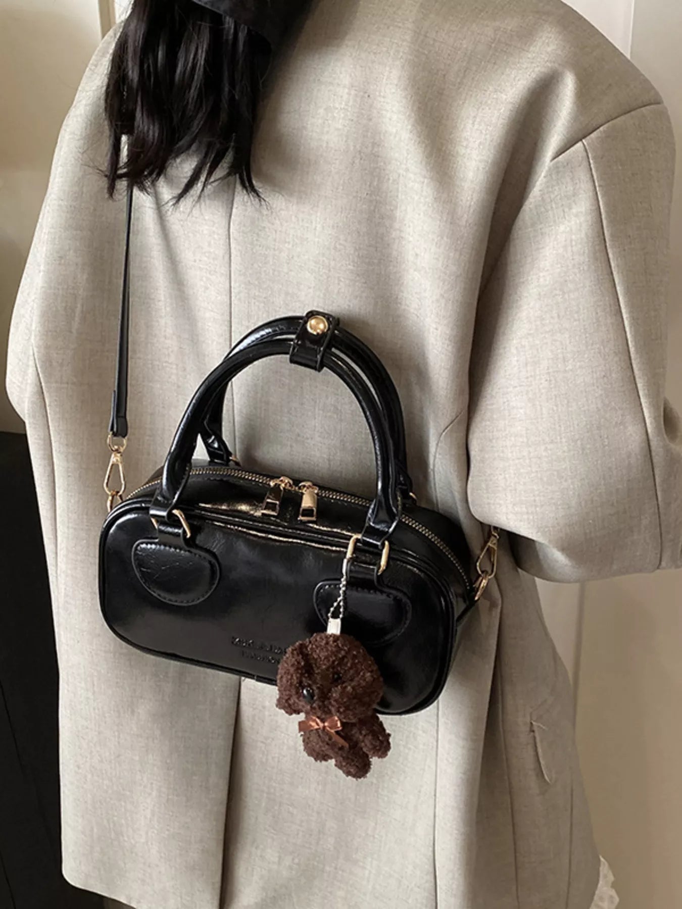 Black mini PU leather crossbody bag with top handles and a fluffy dog charm