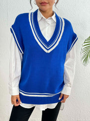 Blue acrylic knit vest with white contrast trim and V-neck, styled over a white shirt.