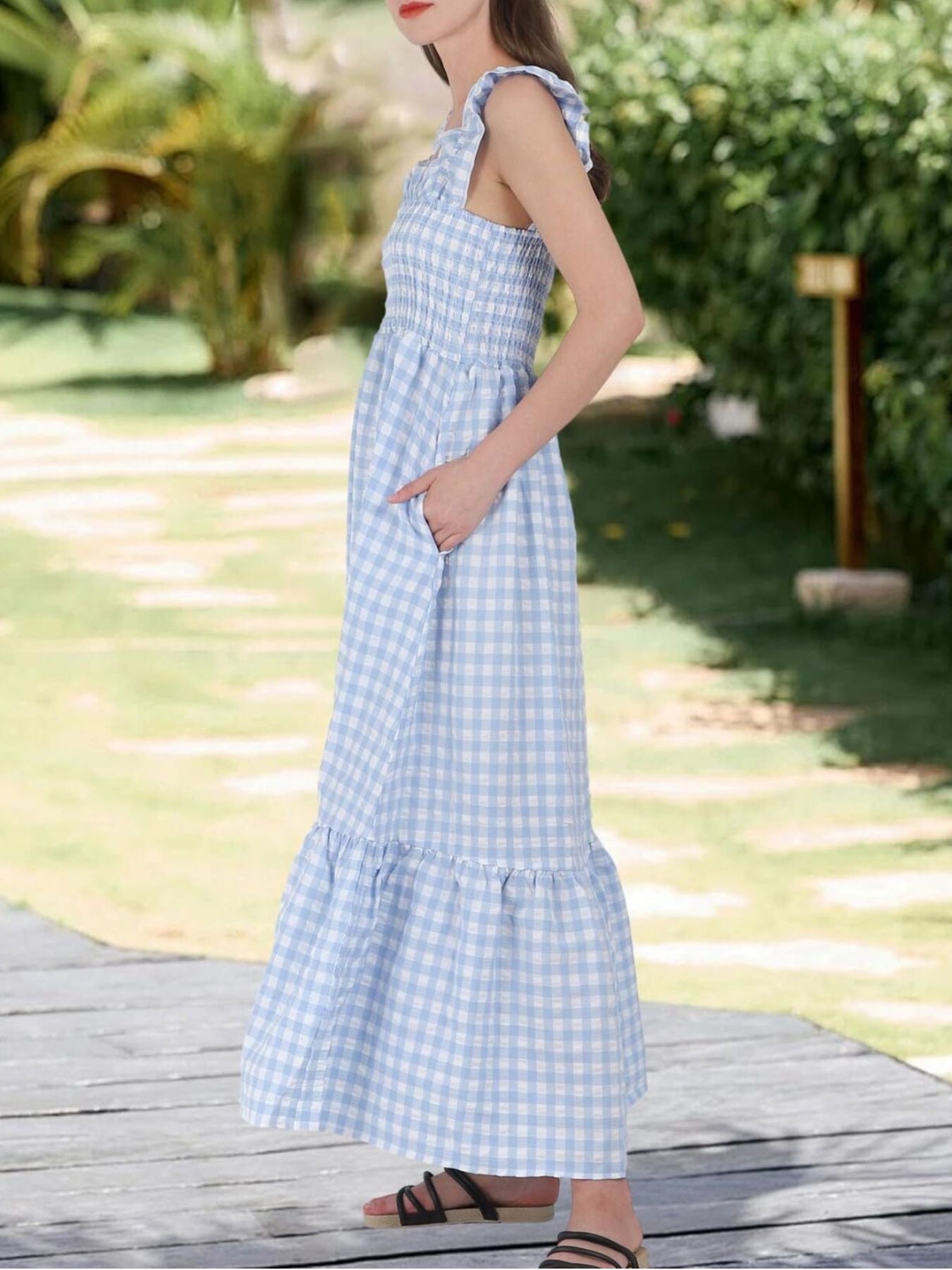 Blue gingham midi dress with smocked bodice, ruffled straps, pockets, and tiered hem.