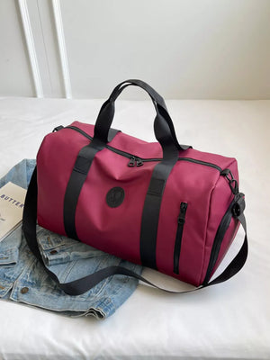 Wine red travel organizer bag with adjustable straps and black accents.